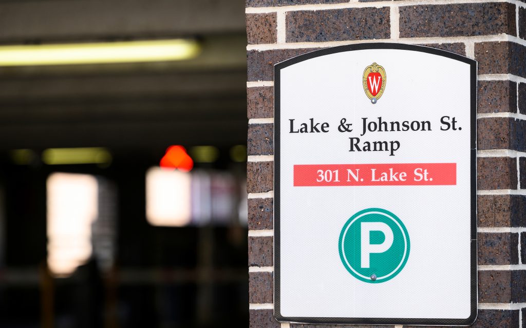 Parking lot sign fixed outside of parking ramp entrance.