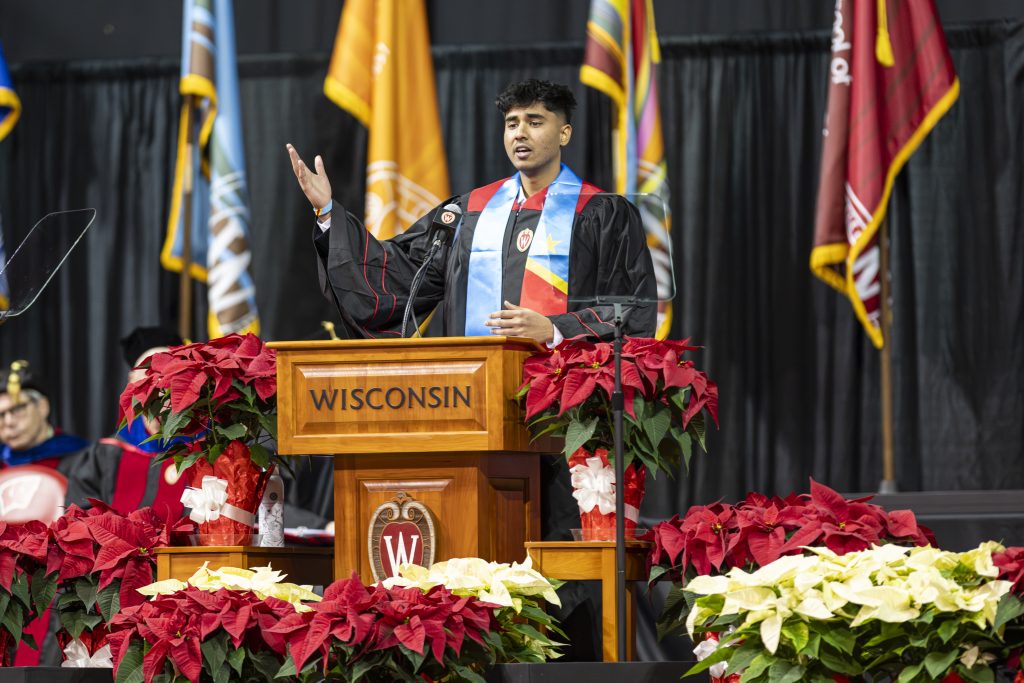 Student speaker Jeeva Premkumar addresses the crowd during the winter commencement ceremony held in the Kohl Center.